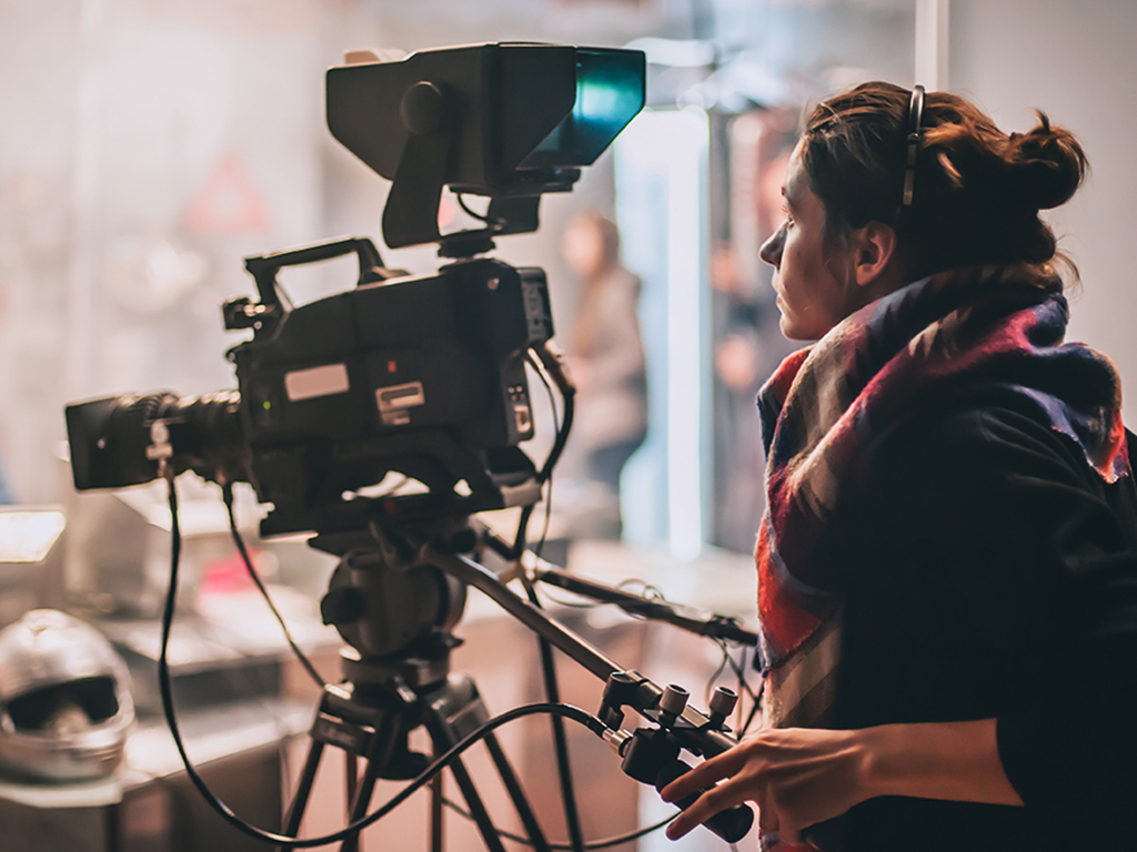 Behind the scene. Actor in front of the camera on the film set in film studio. Group movie scene